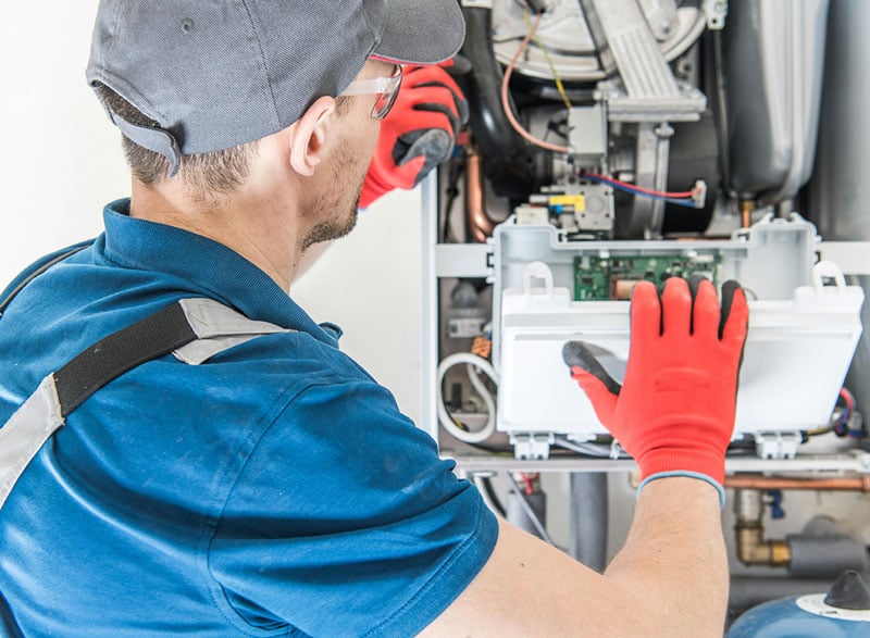 Gas engineer fixing boiler